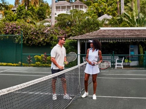 a man and woman on a tennis court