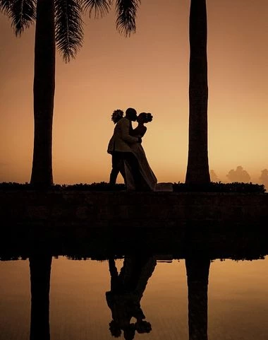 A happy couple in love kissing next to the seashore 