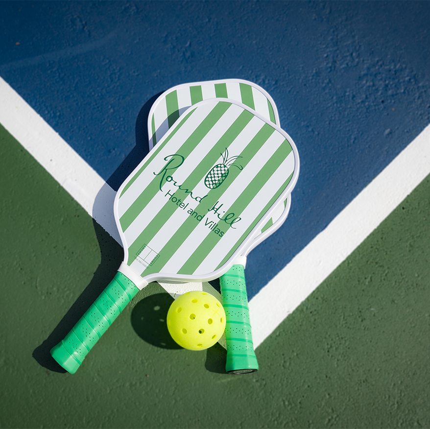 paddles and a ball on a tennis court