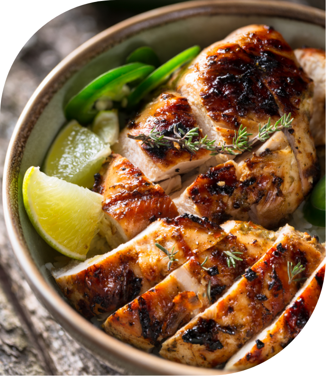a bowl of chicken with limes and herbs