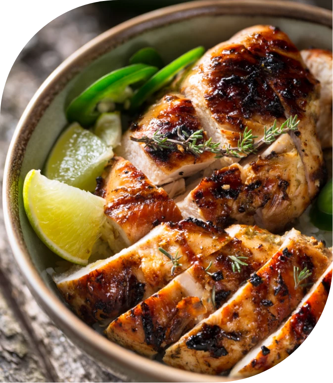 a bowl of chicken with limes and herbs