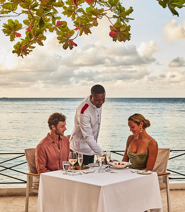 a group of people sitting at a table with food on it