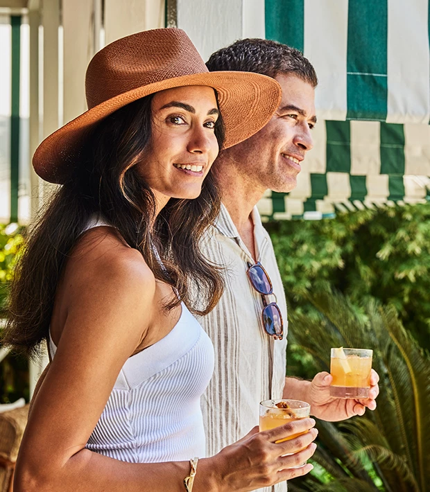 a man and woman holding drinks
