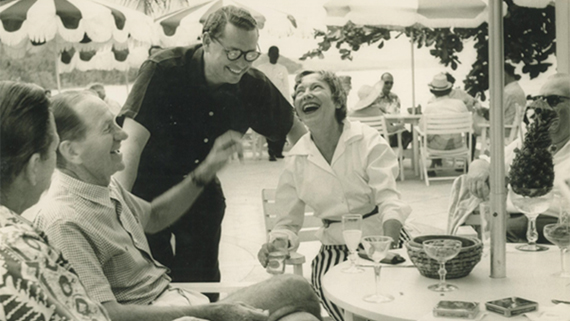 a man and woman laughing at a table