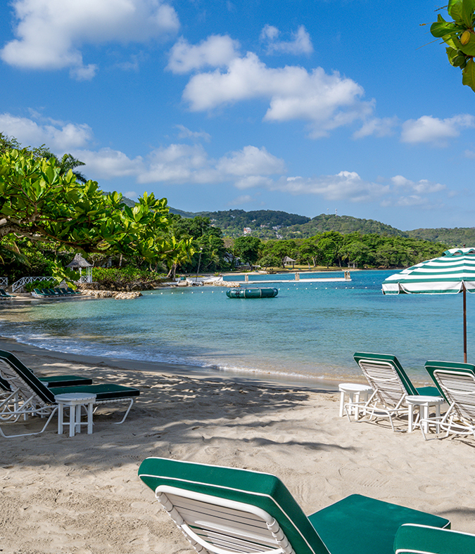 a beach with chairs and umbrellas