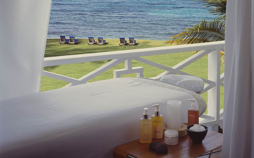 a massage table with a body of water in the background
