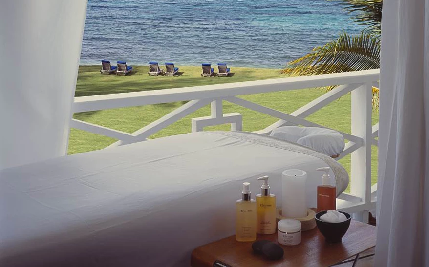 a massage table with a body of water in the background