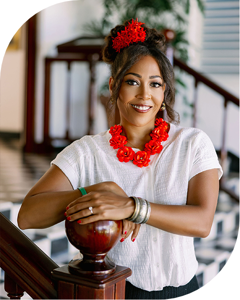 a woman with red necklace and flower necklace