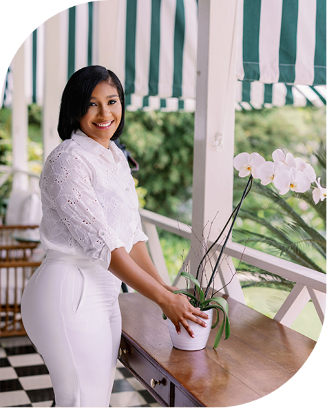 a woman standing next to a plant