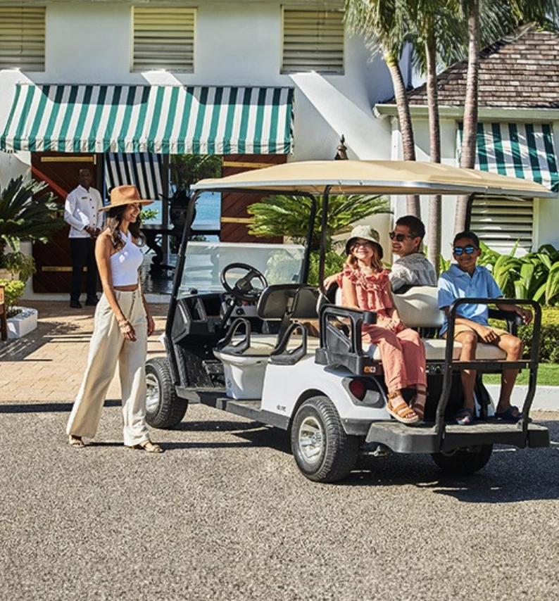 a group of people in a golf cart