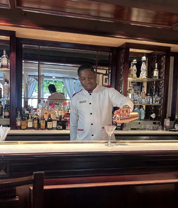 a man pouring a drink into a glass