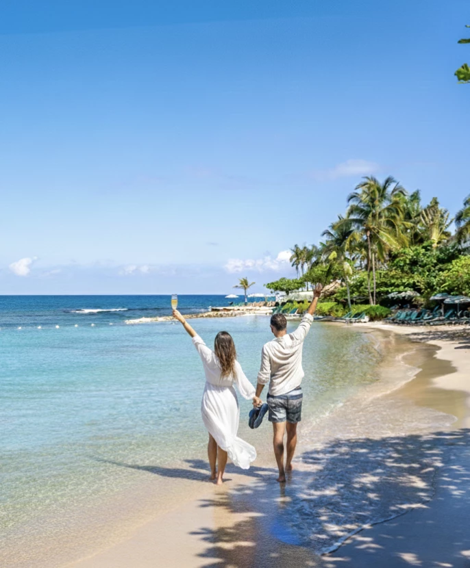 a man and woman holding hands on a beach