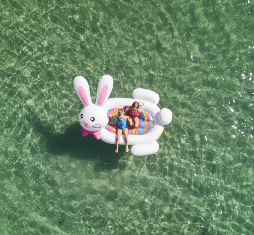 a group of kids on an inflatable raft in the water