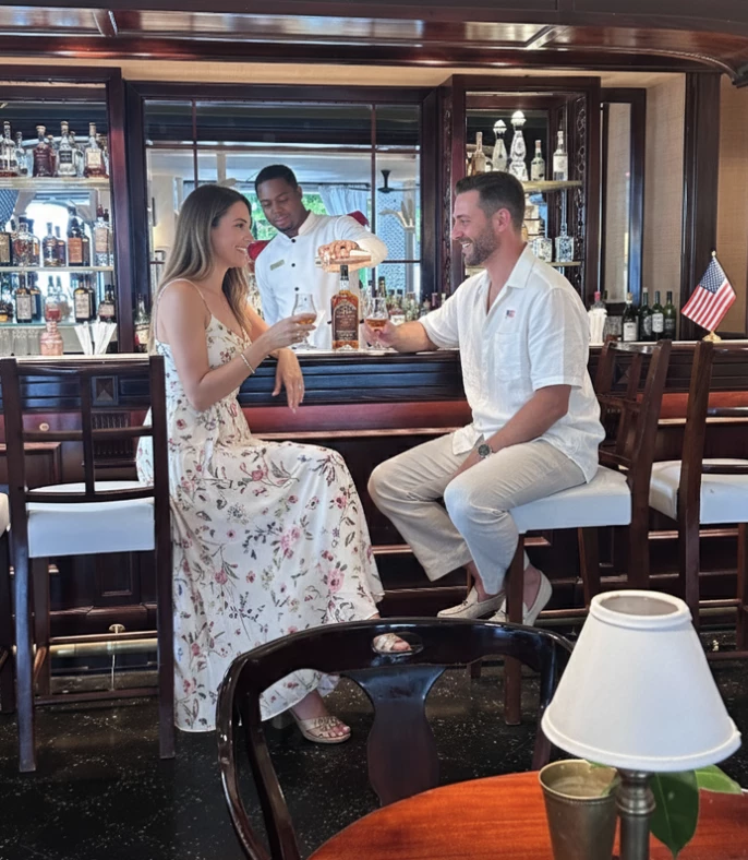 a man and woman sitting at a bar