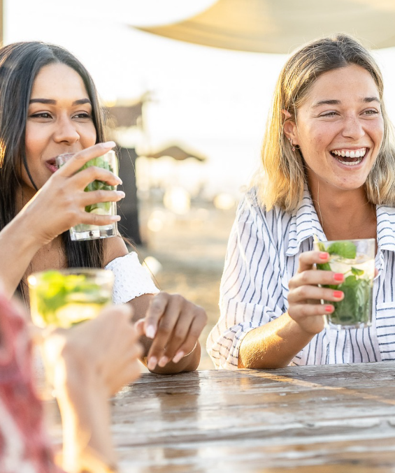 a group of women sitting at a table with drinks