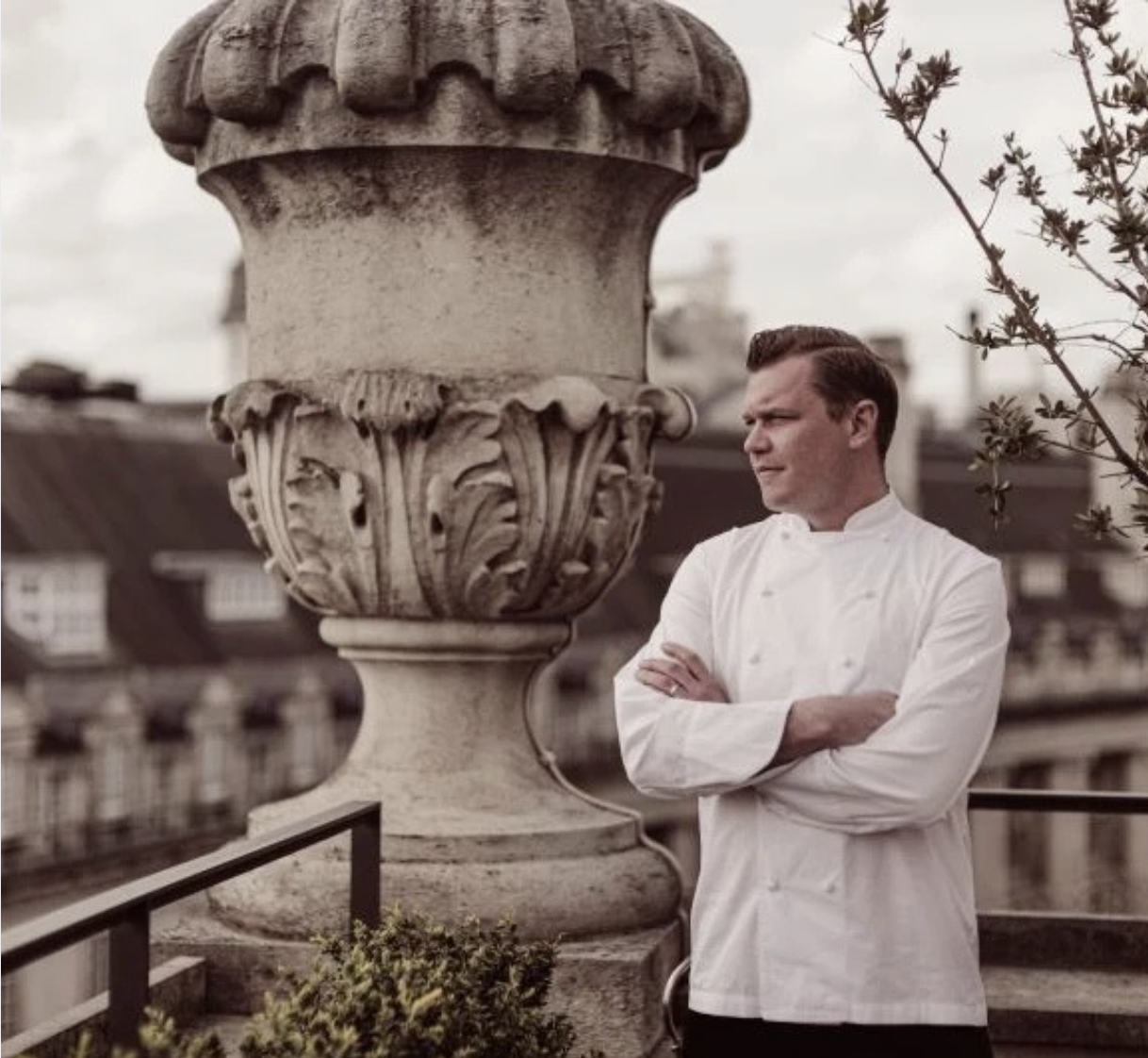 a man standing outside with his arms crossed