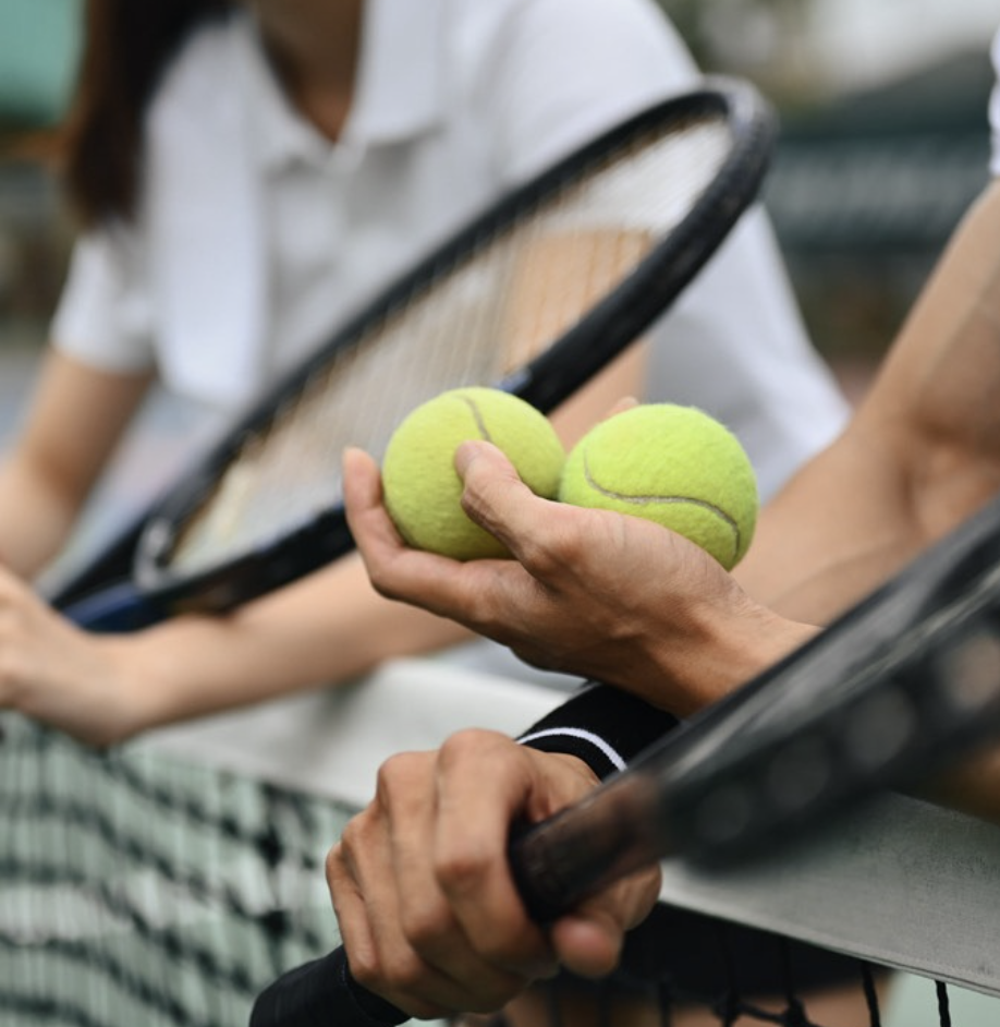 a tennis balls and rackets in a hand