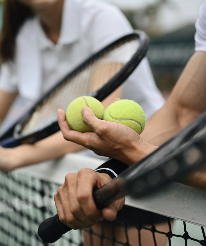 a tennis balls and rackets in a hand