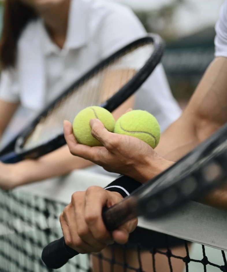 a tennis balls and rackets in a hand