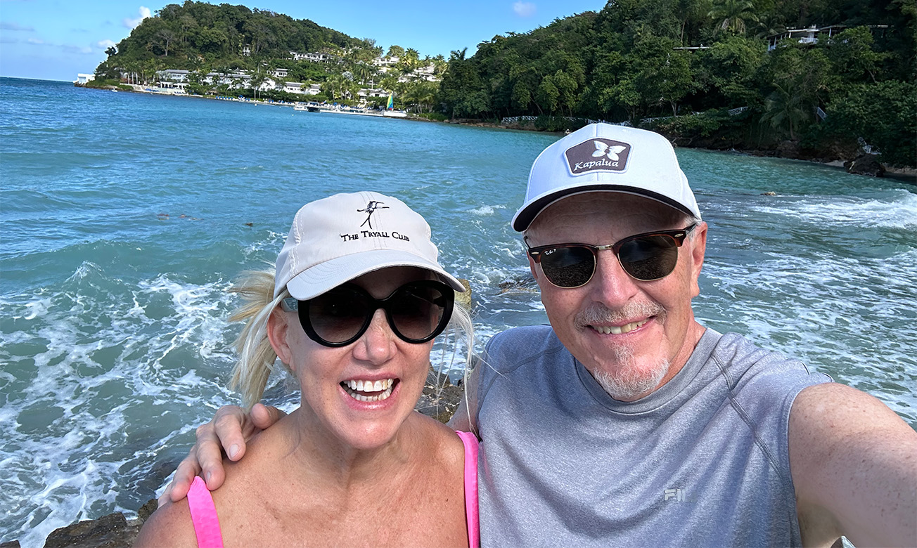 a man and woman taking a selfie in front of water