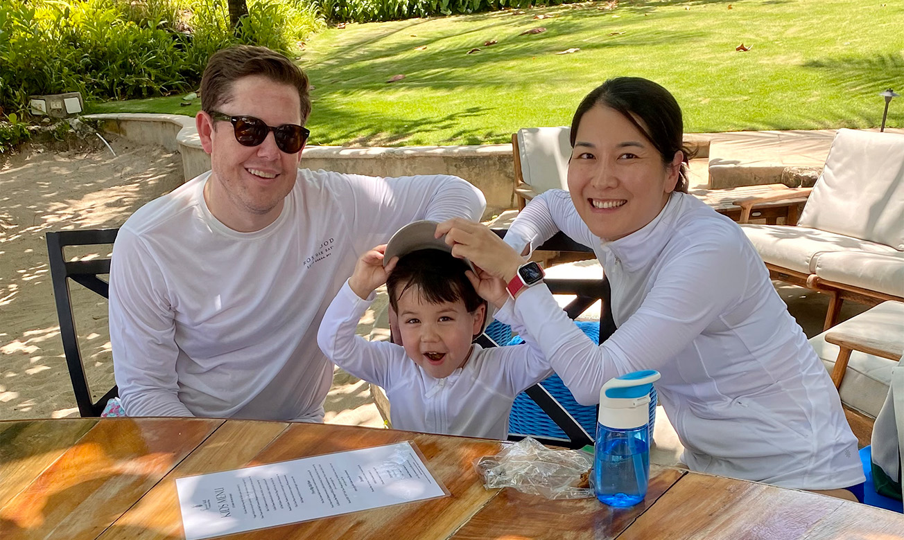 a man and woman with a child at a table