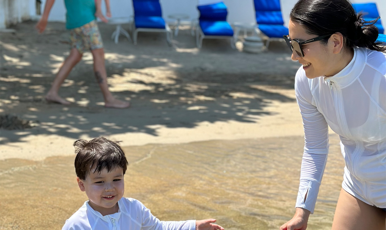 a woman and child playing in water