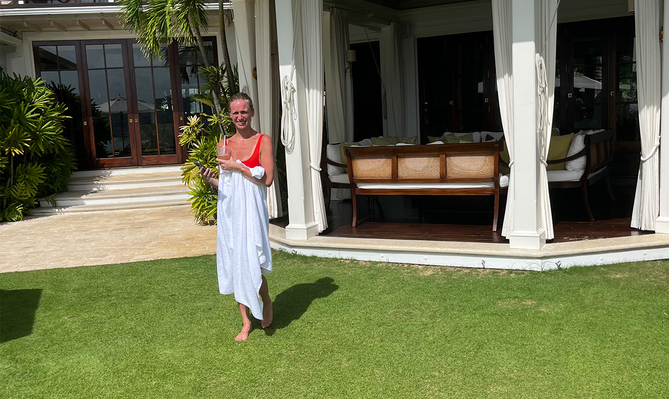 a woman in a white towel holding a drink in her hand