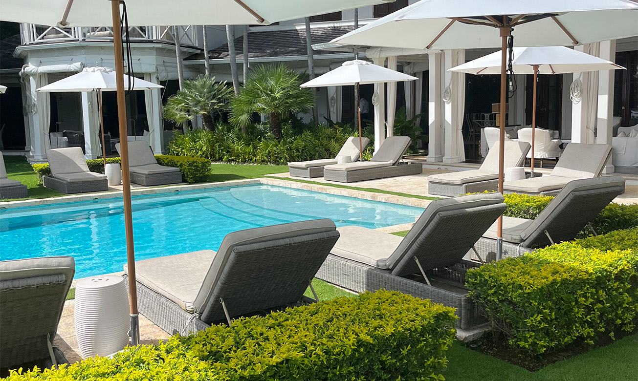 a pool with lounge chairs and umbrellas