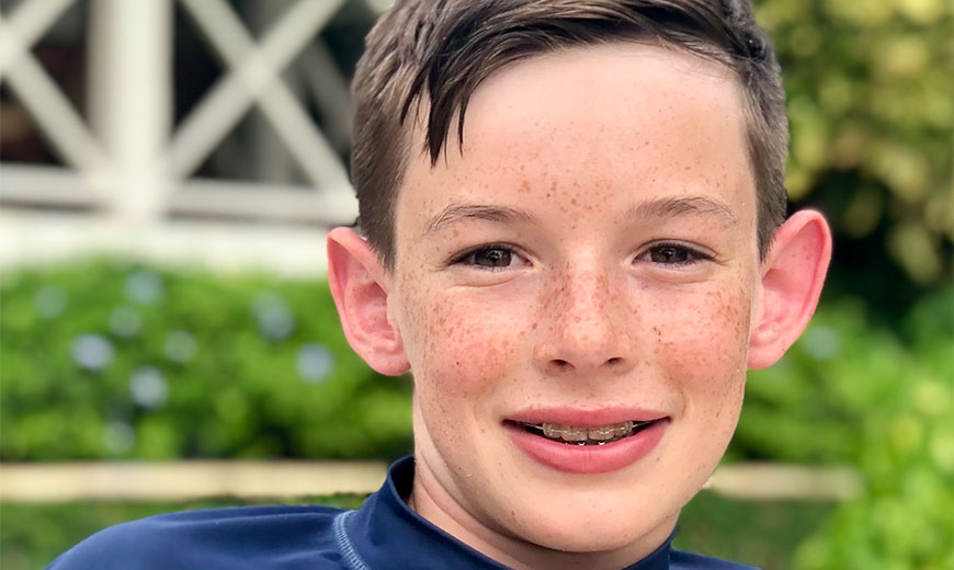 a boy with braces smiling