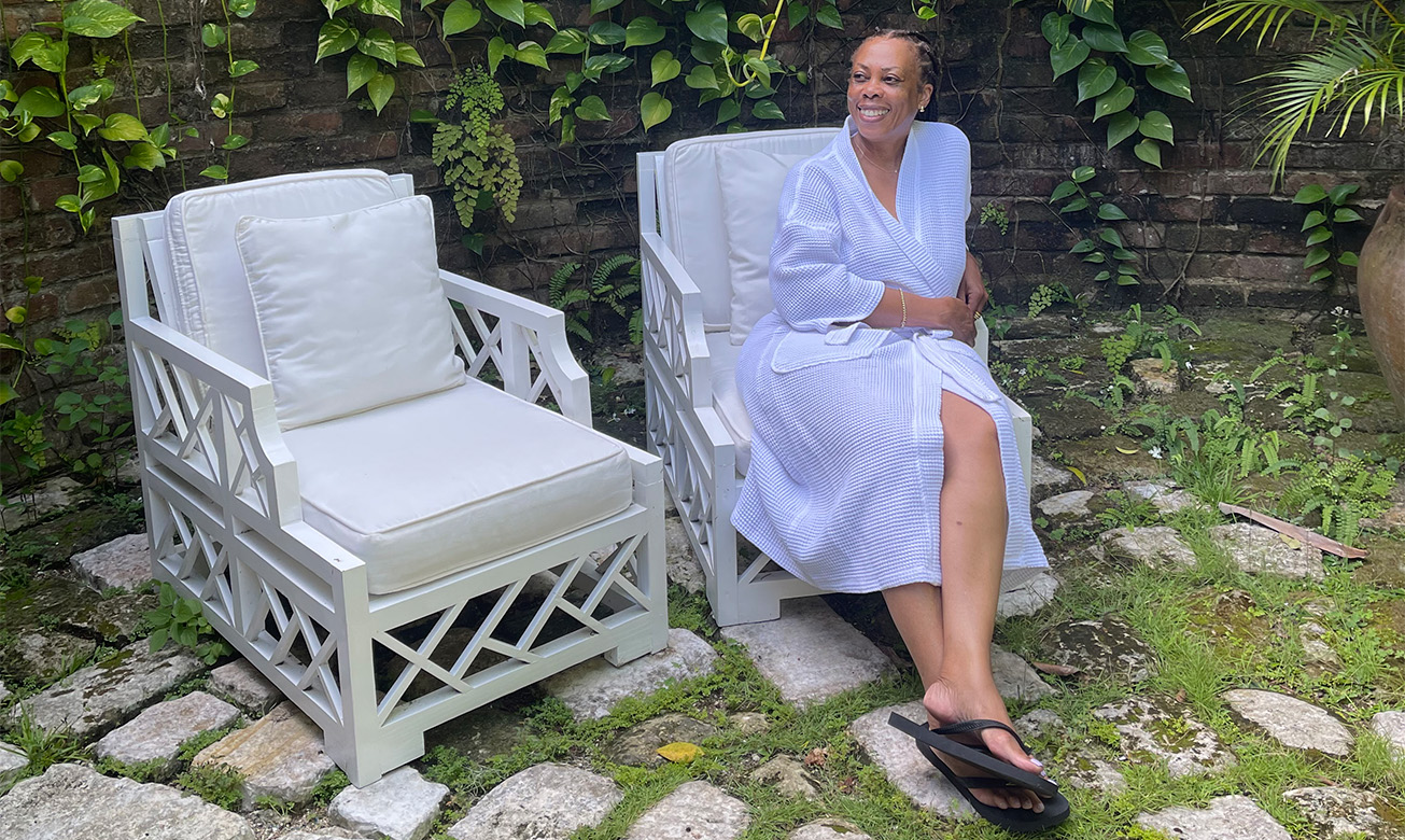 a woman in a robe sitting in a white chair