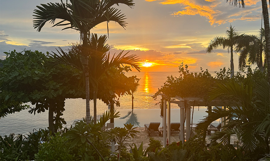 a sun setting over a beach