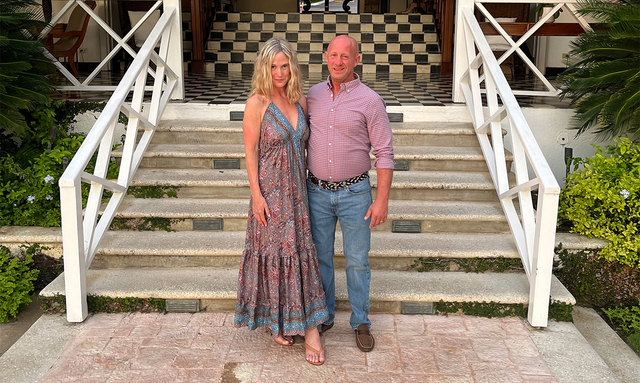 a man and woman standing on stairs