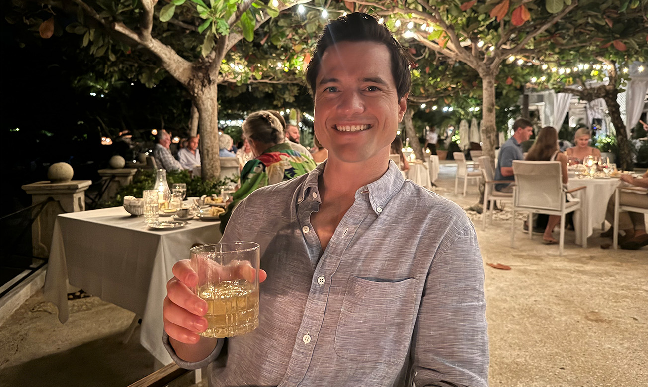 a man holding a glass of liquid