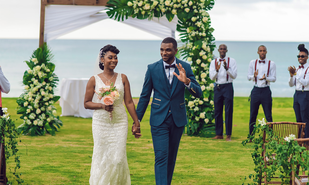 a man and woman walking down a lawn