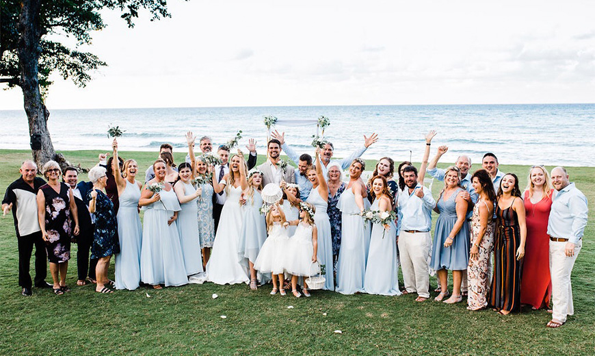 a group of people at a wedding posing for a photo