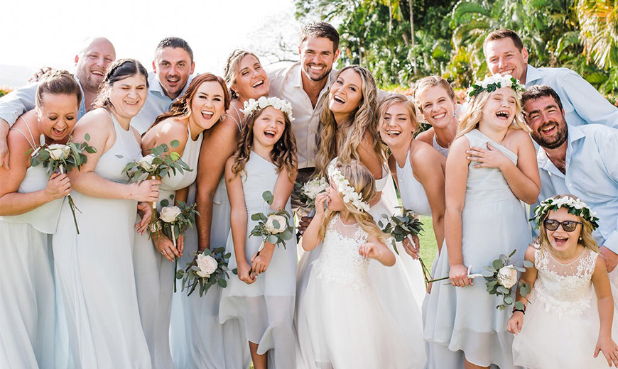 a group of people posing for a photo at a wedding