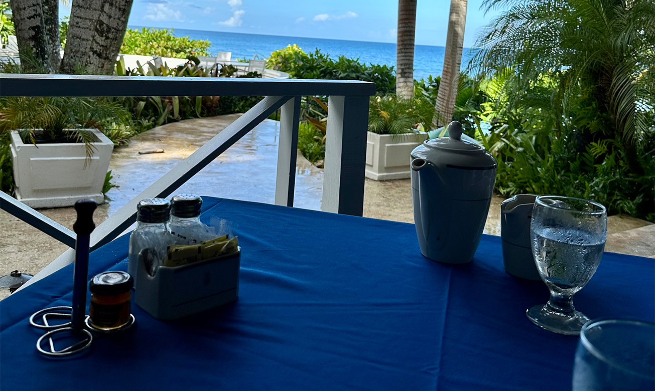 a table with a blue tablecloth and a blue tablecloth with a view of the ocean