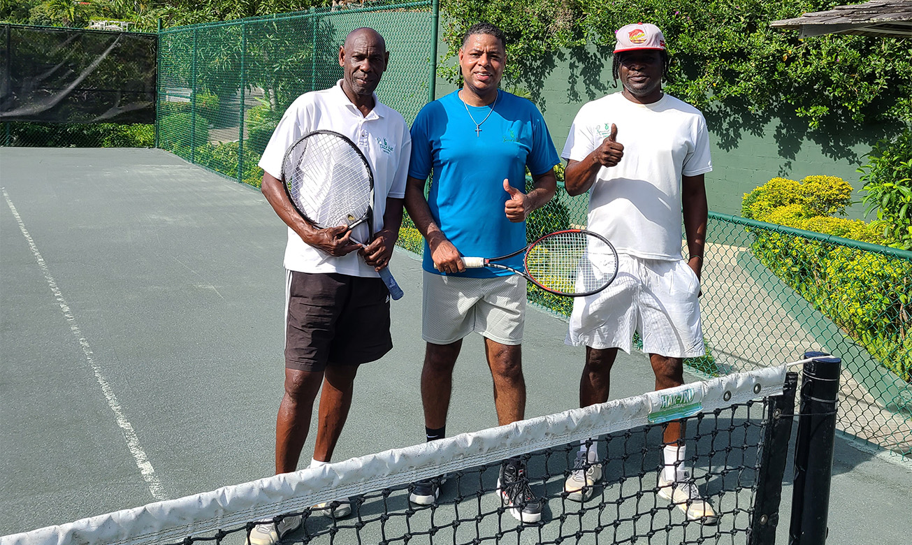 a group of men holding tennis rackets