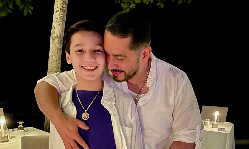 a man hugging a boy