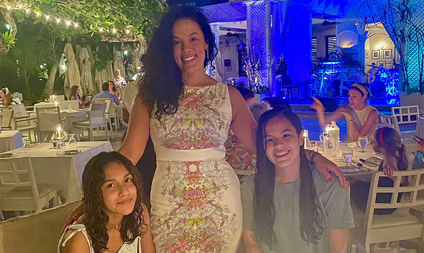 a woman standing with two girls