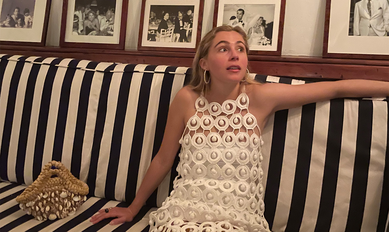 a woman sitting on a striped couch