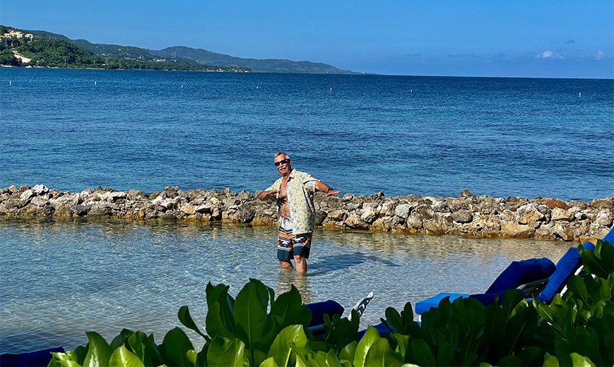 a man standing in water with arms out
