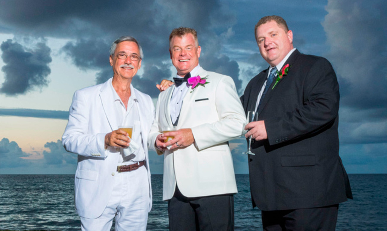 a group of men in suits holding drinks