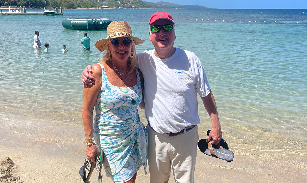 a man and woman standing on a beach