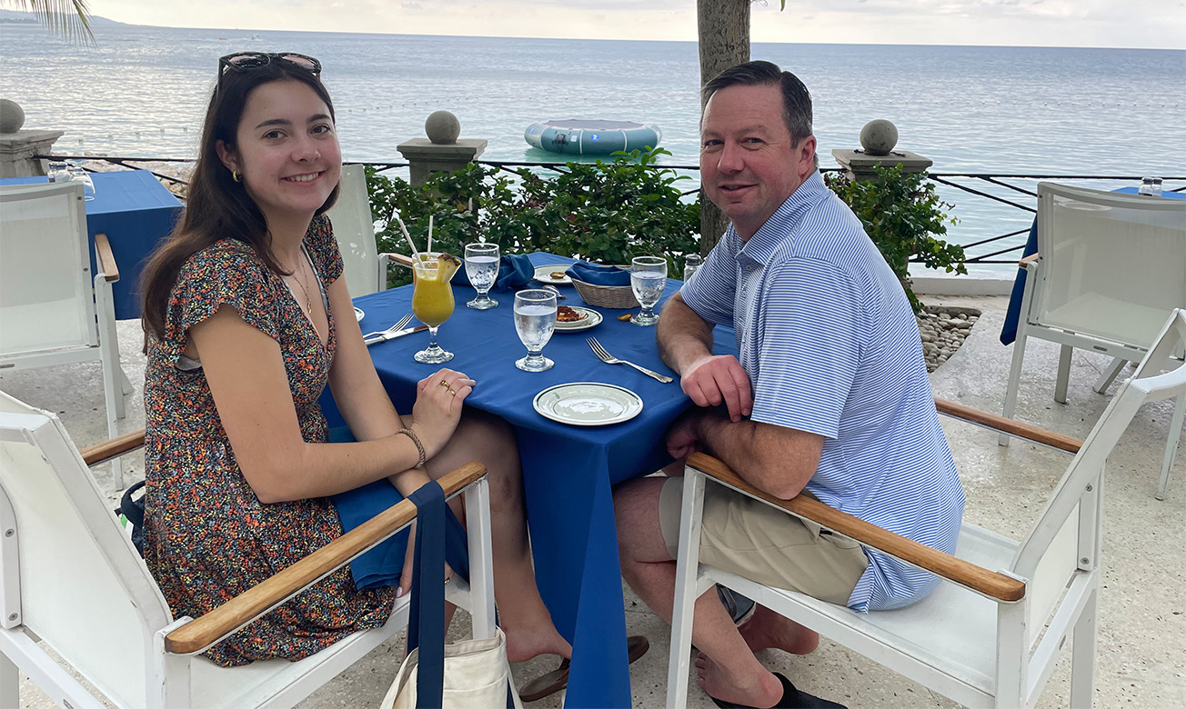 a man and woman sitting at a table with a blue tablecloth