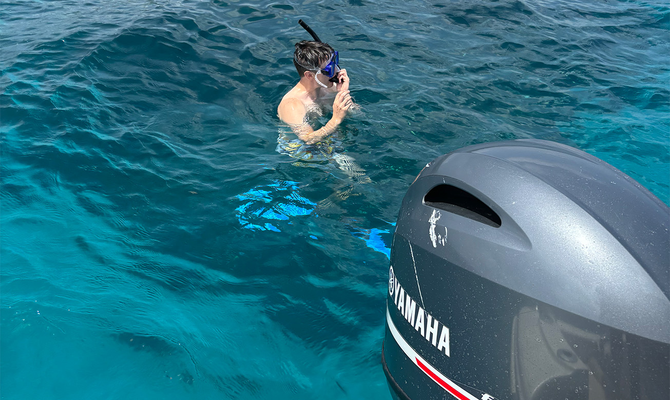 a man in a mask and snorkeling gear in the water