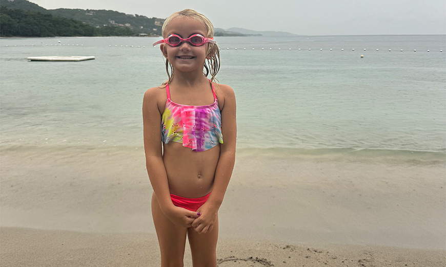 a girl in a swimsuit on a beach