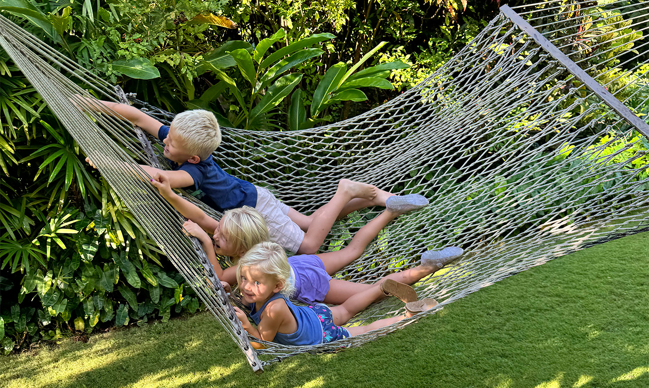 a group of kids lying in a hammock