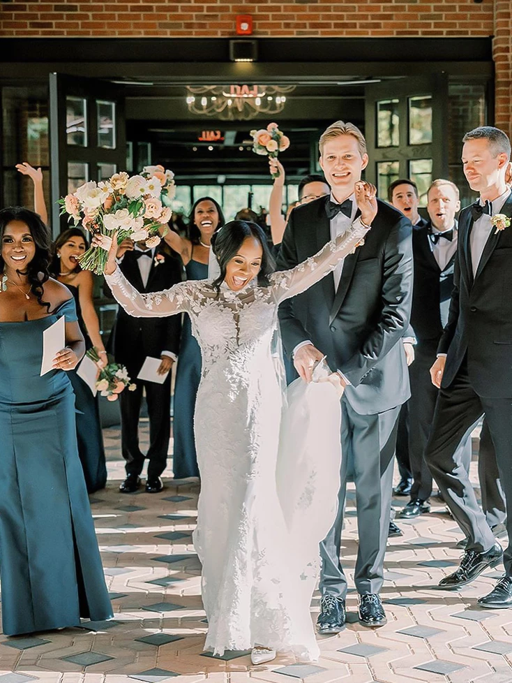 a bride and groom walking down the aisle