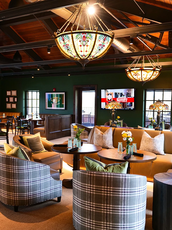 a room with couches and tables and chairs